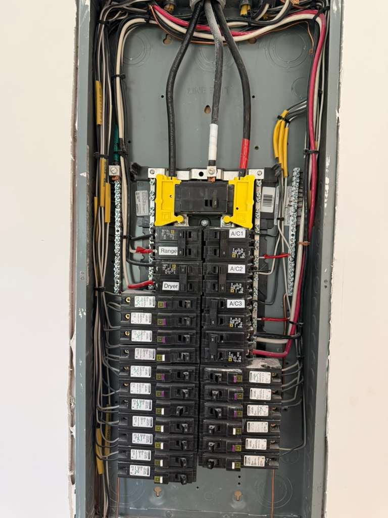 A newly installed electrical panel with an organized wiring system and clearly labeled breakers. The panel appears to be modern and up to code, enhancing the safety and efficiency of the electrical system.