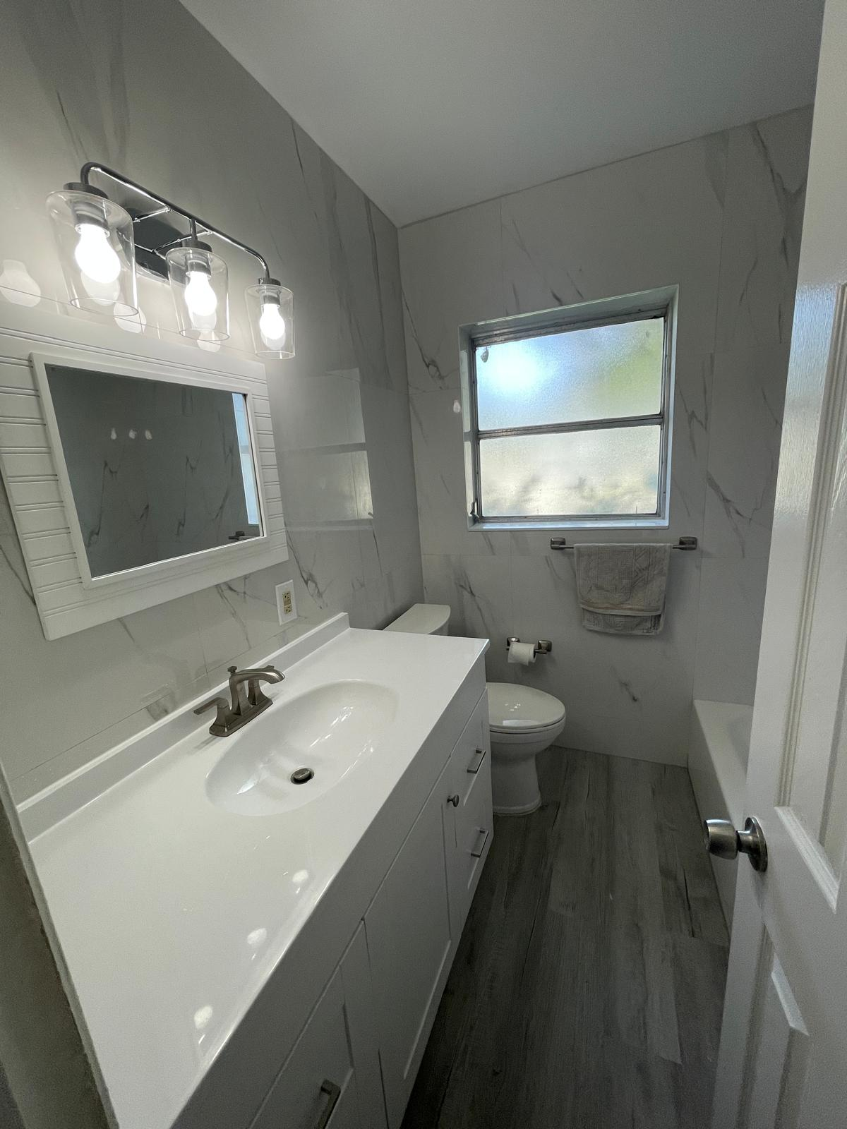 Modern bathroom remodel with marble walls